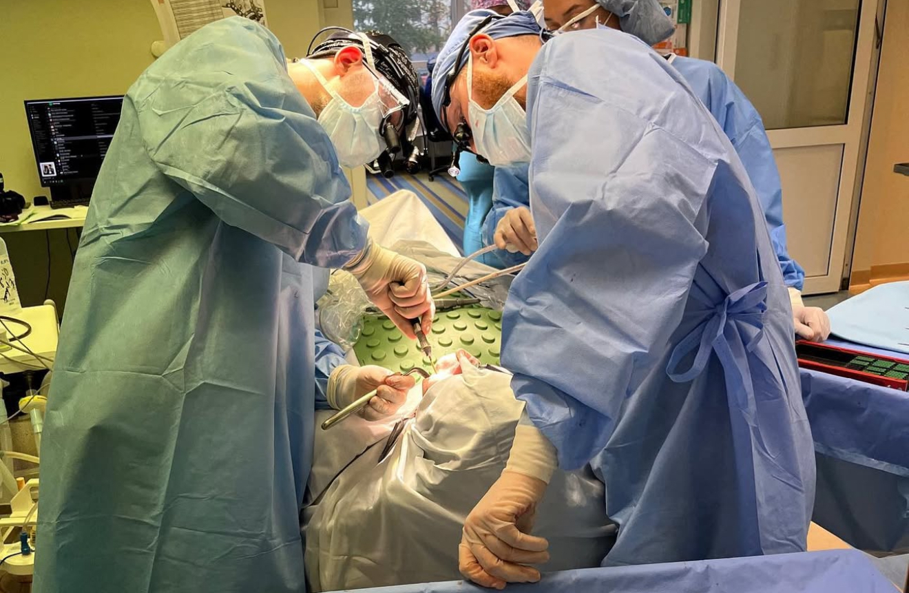 Surgical team performing oral surgery procedure